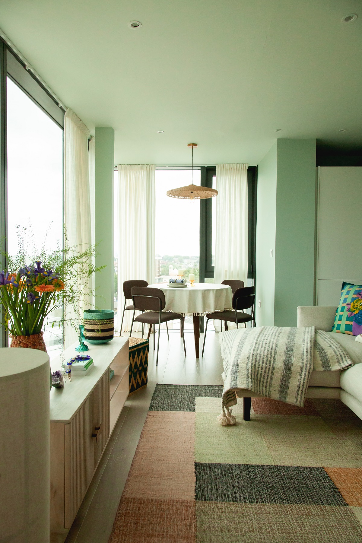 green and white and wood interior by Be-kin with bedroom leading onto dining area with a view over finsbury park