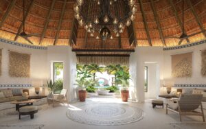 hotel lobby with thatched pitched room wooden furniture and natural surfaces and doors leading through to garden