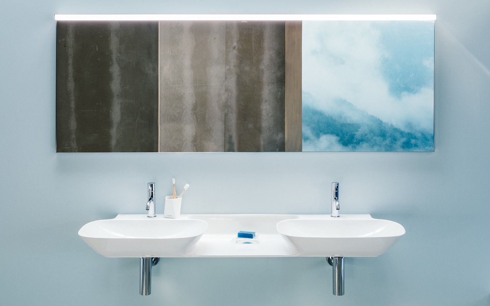 double basin from LAUFEN with wall hung vanity above with mirror and reflections of clouds