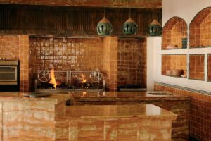 marble and stone surfaces surrounding the open fire stove in the hotel restaurant at Maroma