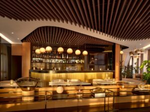 restaurant and bar with curved wooden ceiling in wood and contemporary lighting fittings along the bar