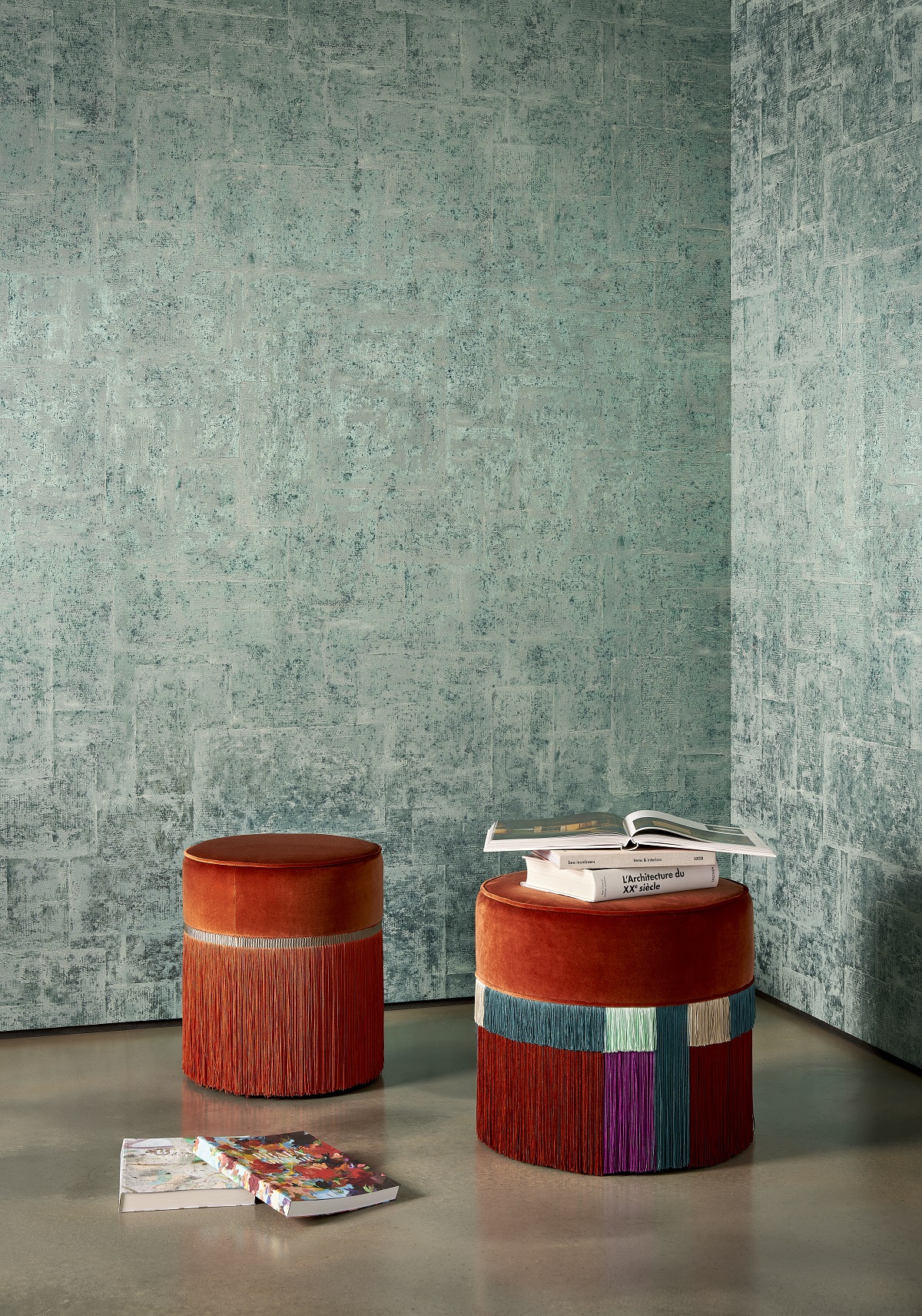 muted grey green wallcovering with square textured pattern on the wall behind dark orange velvet stools