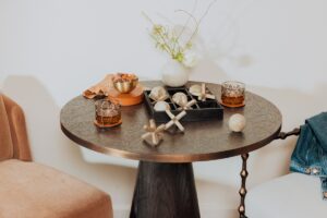 small round wooden table with decorative board game and glasses of whiskey 