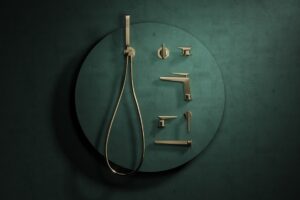 the Foile collection of brassware from Crosswater mounted against a dark green background