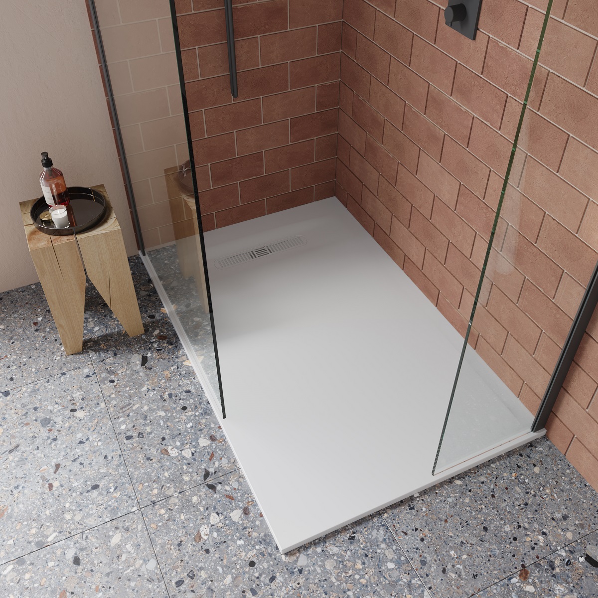 walk in shower cubicle with glass splashback screen and brick tiles against the wall