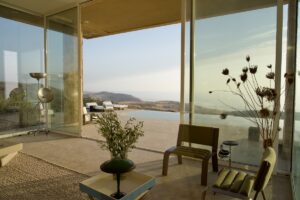 glass doors open up entire wall of villa integrating indoor and outdoor space