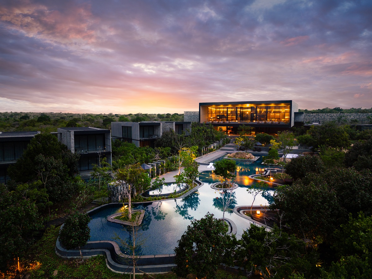 aerial view of exterior of Hilton Yala Resort looking over the pool towards the hotel