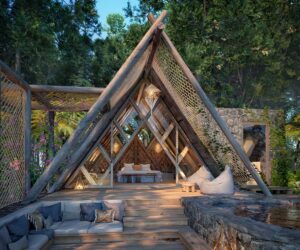 A-frame hotel guestroom set in nature using wood and stone