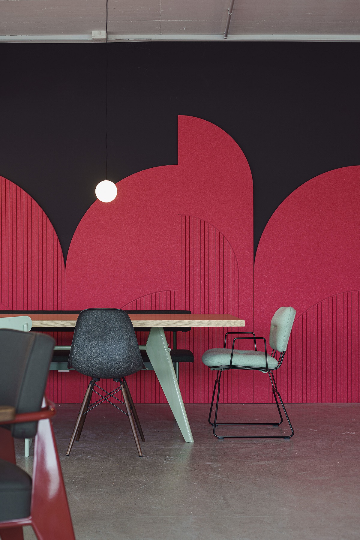 Red and black wall in front of dining table