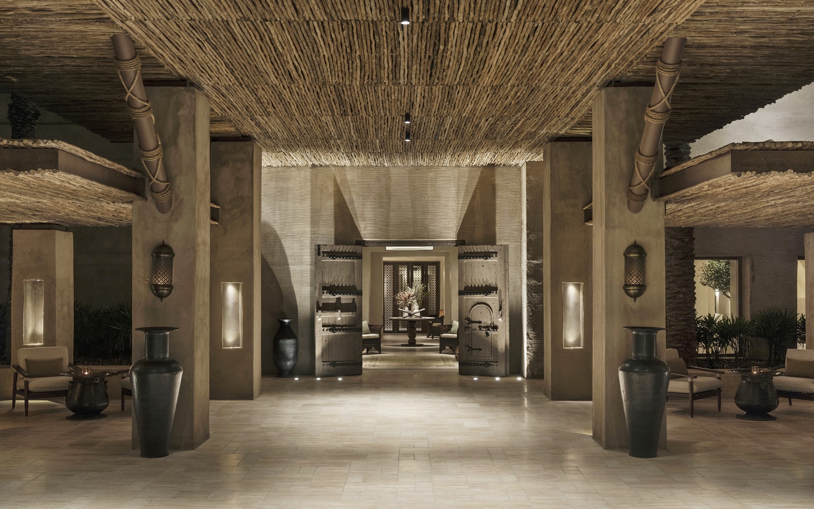 wood and stone colours in dramatic pillared hotel entrance at Bab Al shams