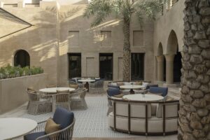central courtyard with arabic style architecture , desert colours and palm trees
