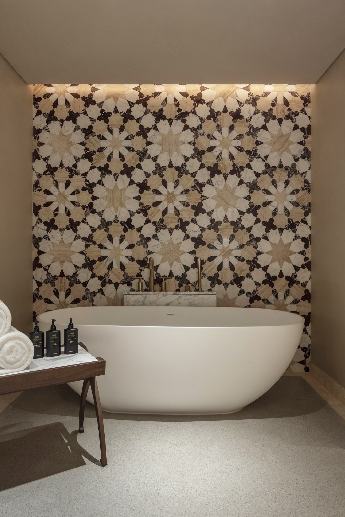 bold arabic mosaic design behind freestanding bath