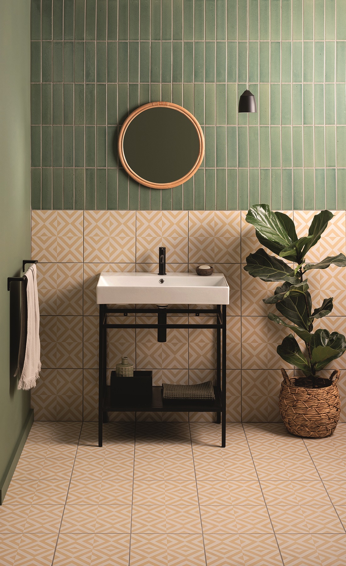 yellow patterned floor tiles contrast with green wall tiles with industrial style washbasin and green plant in cloakroom design