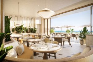cream, linen and stone coloured restaurant interior overlooking Miami beachfront