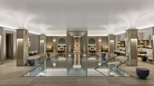 curved ceiling with lighting above indoor spa and swimming pool with arched niches around the wall for seating