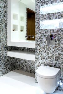 silver, grey and black mosaic surfaces in small cloakroom design