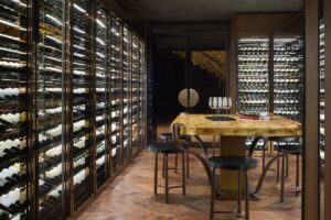 private dining and tasting table in a room with floor to ceiling wine storage