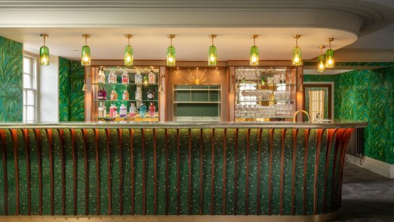 bar counter with green mosaic surface by TREND mosaics and green glass lights above