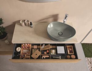 moss grey green hand basin in organic shape on vanity with organised open drawer by Villeroy & Boch