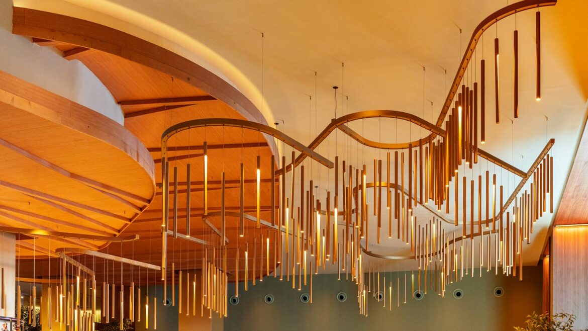 a customised lighting design in a hotel lobby with curved structure supporting metal rods