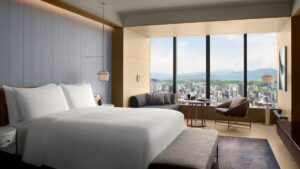 soft grey and white with wood surfaces in the guestroom of The Ritz-Carlton, Fukuoka with views over the city