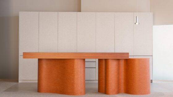orange curved and organic shaped table and counter top in the Tarkett showroom