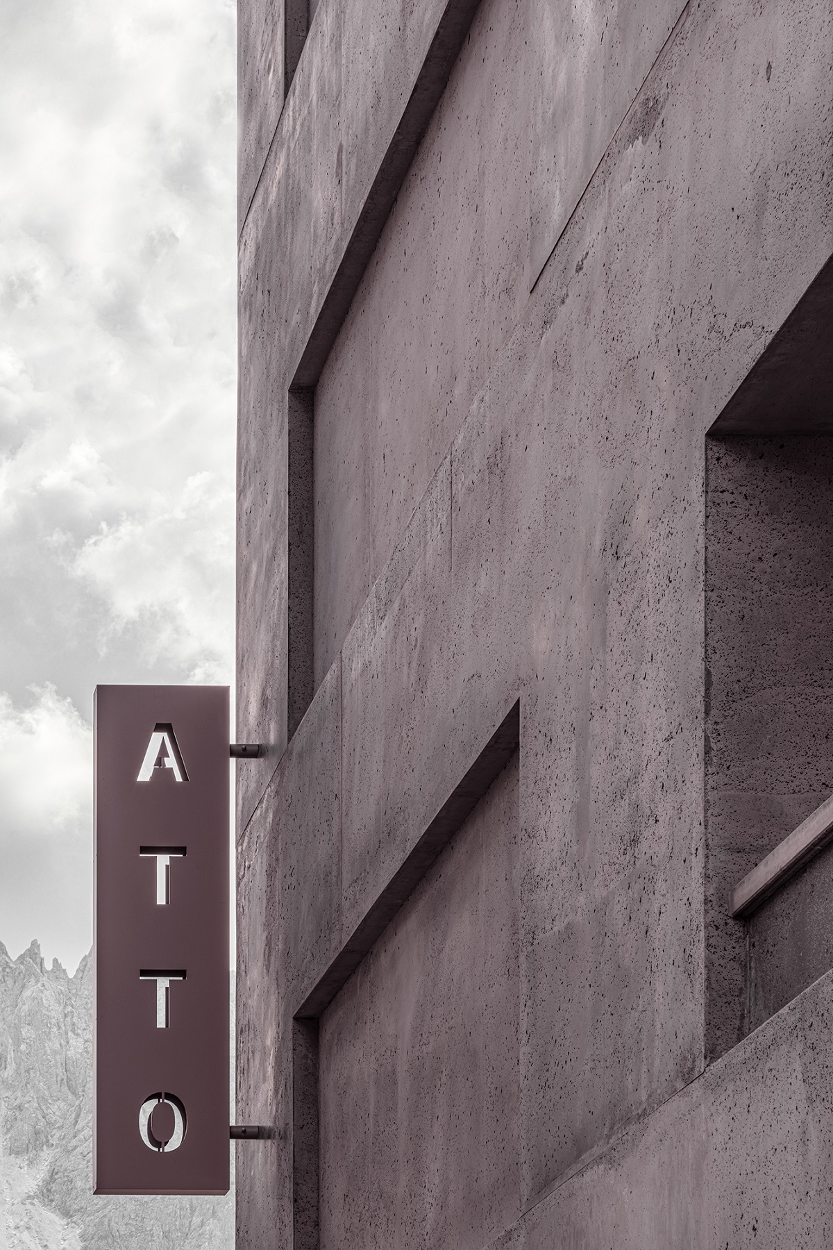 brutalist concrete facade with hotel signage