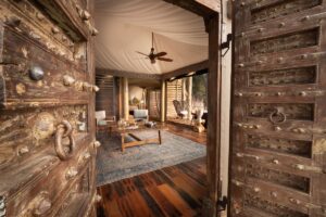 heavy studded antique wooden door opening onto guest suite at Sitatunga Private Island