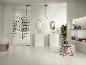 bathroom set showcasing marble marvel meraviglio in grey and white by Atlas concorde and patterned tiles in black and white on back shower wall
