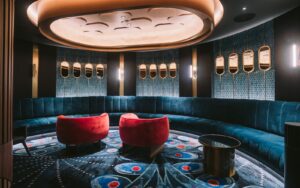 dark interior of bar with focus lighting over bespoke modieus carpet in blue and red in casino