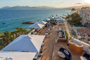 umbrella tops and wooden decks on the rooftop of Canopy Hilton Cannes