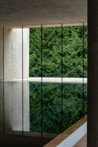 minimalist concrete walls and window onto the gardens from the Cowley Manor spa and Pool