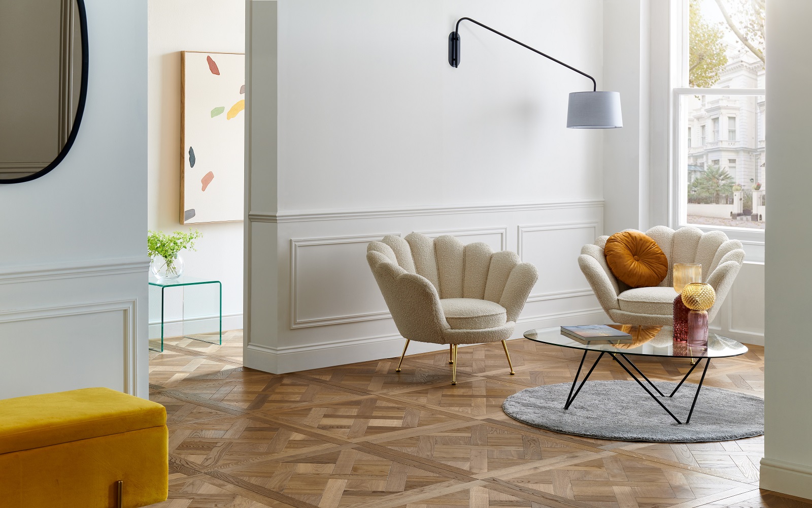 apartment with wood parquet flooring, white walls and cream and mustard furniture