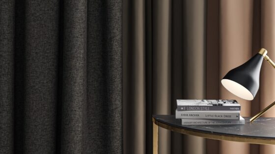 curtains in brown and charcoal from Sekers ESME collection behind a table with books and reading lamp