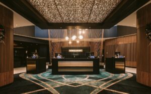 statement ceiling lighting above bespoke designed carpet in blues and golds by Modieus in casino reception