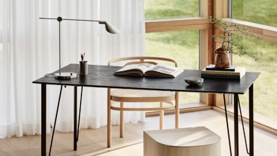 minimalist table as a desk with open book and MS lamp from Fritz Hansen in front of a window