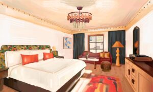 hotel guestroom rendering with patterned carpet on wooden floor, green curtain and green and orange soft furnishings as accents