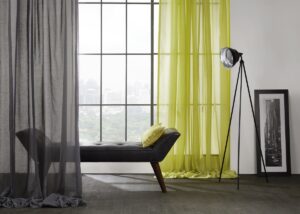 grey and yellow voile in front of window with chaise lounge and studio light