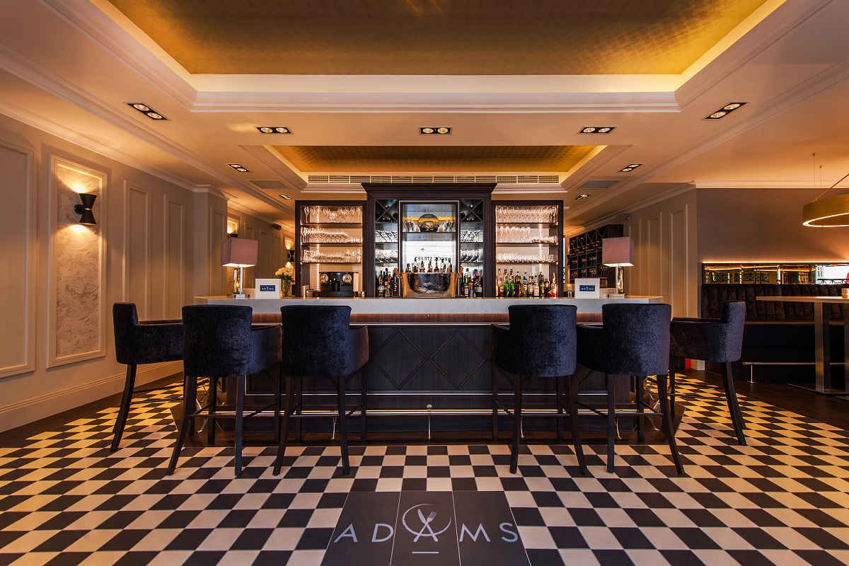 Contemporary hotel bar, with black and white floor tiles