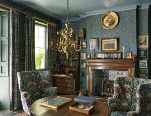 william morris design in the emery walker house with fireplace and brass chandelier