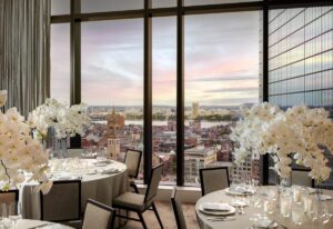 statement white floral centrepieces on ballroom tables in Raffles Boston with views across the city