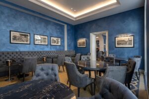 dark blue walls and blue upholstered furniture in hotel restaurant
