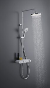 Chrome shower system with water flowing against a grey wall