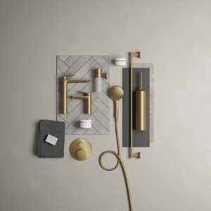 a range of brass shower fittings and taps and bathroom accessories in a flatpack shot from above