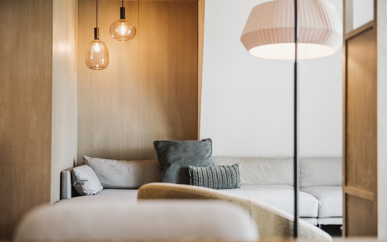 cosy corner in hotel Seeblick apartment with wood clad walls, woollen textiles and soft lighting