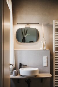 grey, beige and wood in hotel bathroom designed by NOA