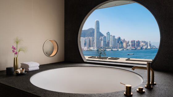 A circular window in hotel bathroom overlooking Hong Kong
