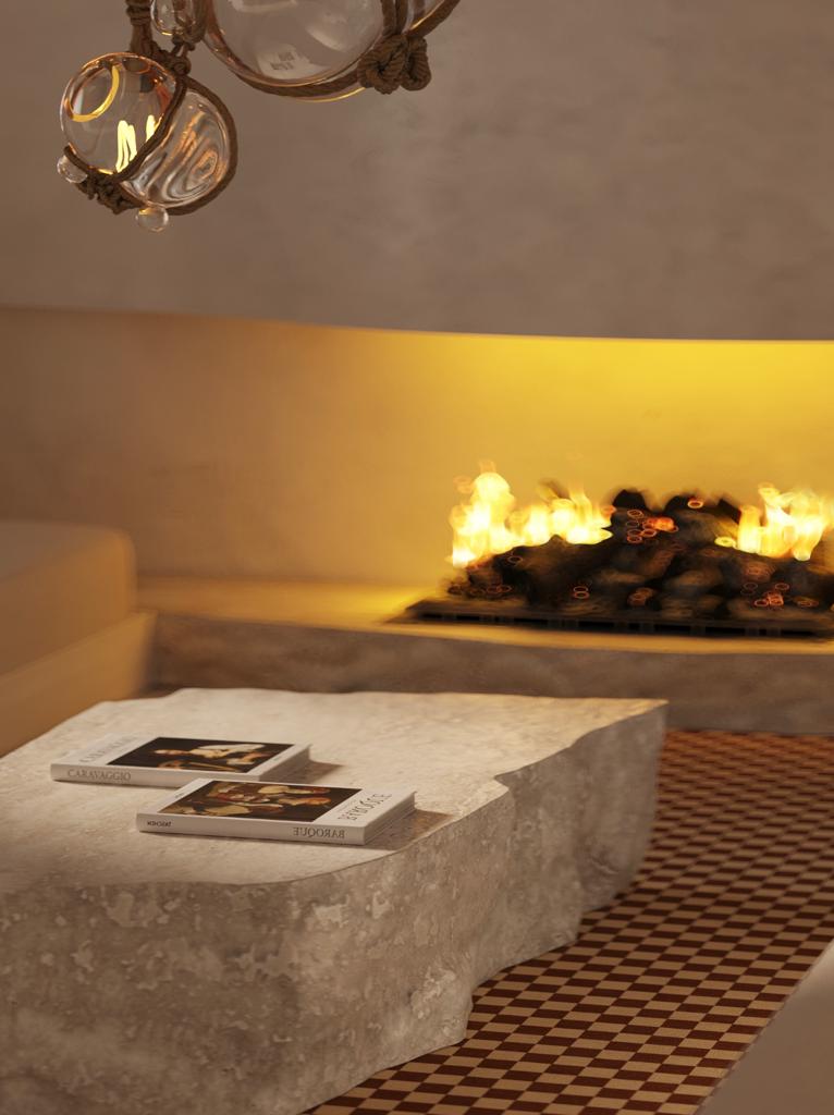detail of chandelier in front of fireplace and stone table in cream seating area of Ibiza villa