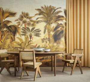 wooden chairs and table in front of floor to ceiling wallcovering with palm tree print