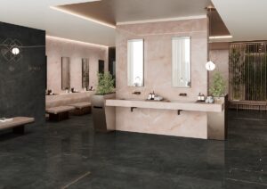 guest bathroom with multiple basins and mirrors on light pink marvel onyx surface contrasted with surrounding in darker brown and black tiles